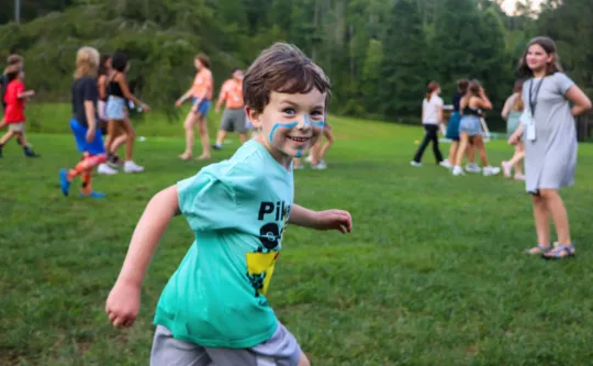 A boy running in the field.