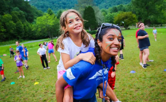 A counselor and camper smile at Camp Watia.