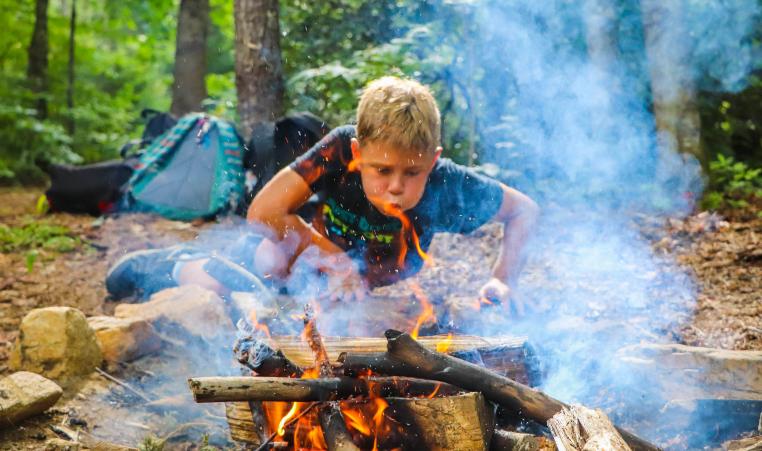 boy building a fire